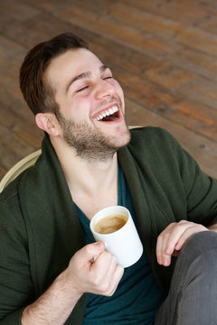 Man relaxing at home with cup of coffee