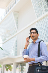 indian business man with smart phone with office background