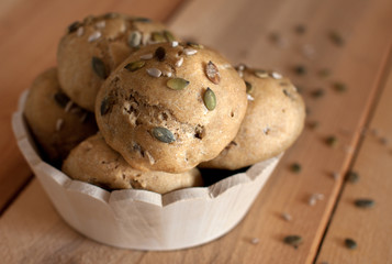 multigrain buns in wooden bowl