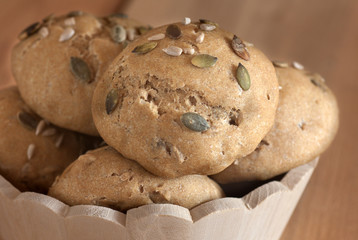 multigrain buns in wooden bowl