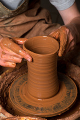 Fototapeta na wymiar hands of a potter, creating an earthen jar