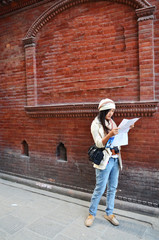 Traveler Thai woman with map at Thamel Kathmandu Nepal