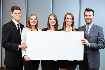 Group of business people holding billboard in the office
