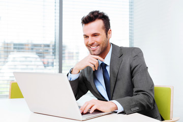 Fototapeta premium Happy businessman browsing web
