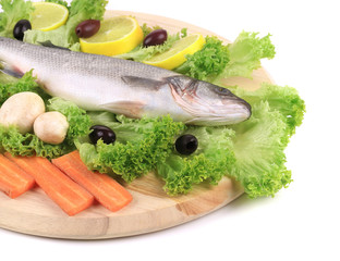 Fresh seabass on platter with lettuce.