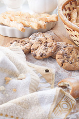 Obraz na płótnie Canvas Oat cookies with slices of chocolate lie on a table with a flour