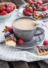 Cup of coffee and chocolate eclairs