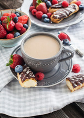Cup of coffee and chocolate eclairs