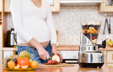 Pregnancy and nutrition - pregnant woman with fruits
