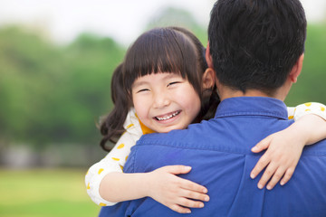 Obraz premium happy little girl hugging embracing her father