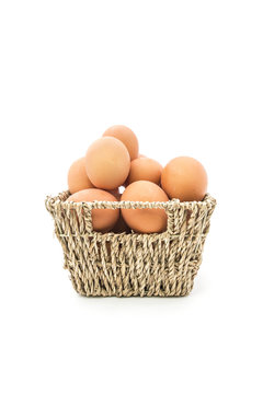 Fresh eggs in basket on white background