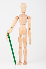 Small wood mannequin standing with colour pencil isolated on whi