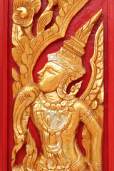 Fototapeta na wymiar thai style golden carving art on the wall temple