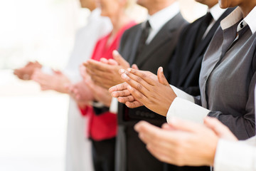 group of businesspeople clapping hands