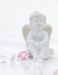 A little miniature statue of a white angel with wings on a white