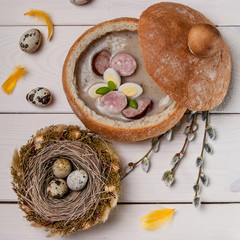 White borscht and nest with eggs on wood