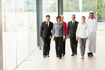 group of businesspeople walking in office building