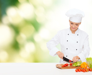 smiling female chef chopping vagetables
