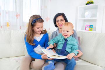 Grandmother reading to grandchildren