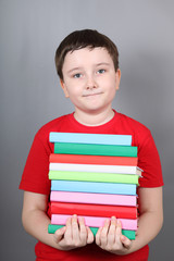 Boy with a pile of books