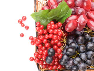 Fresh cranberries and grapes in basket isolated on white backgro