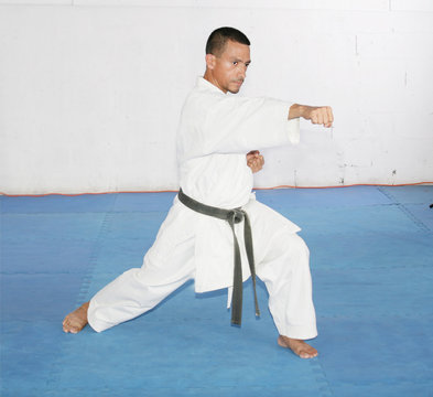 Black belt Man in kimono during training karate kata exercises i