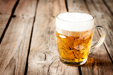 Beer mug on vintage rustic wood table - pub menu