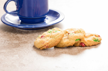 Three fresh cookies with coffee mug