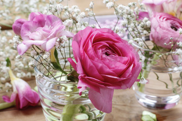 Florist workplace: incomplete tiny bouquets in glass vases. Step