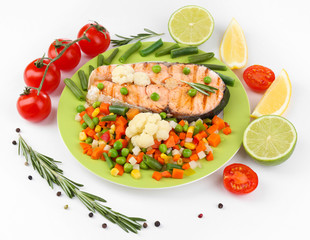 Tasty grilled salmon with vegetables, isolated on white