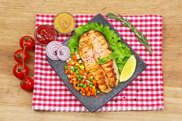 Fototapeta na wymiar Tasty grilled salmon with vegetables, on wooden table