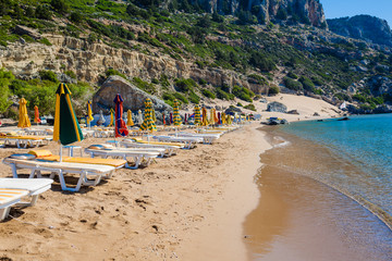 view of the beach with chairs and umbrellas