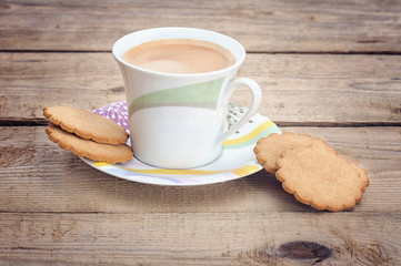 ginger cookies and a cup of coffee on old wood background