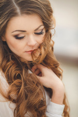 Portrait of a young brunette in the spring garden