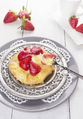 pastry pie with strawberries and custard on silver plate