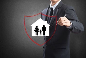 Shield protecting family and house, insurance concept