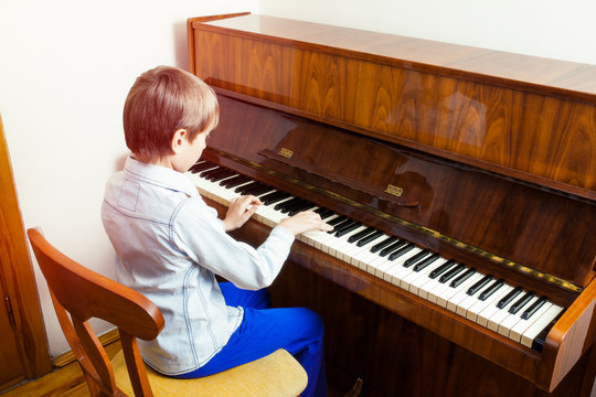 Cute llittle child playing piano