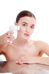 Woman with brush for deep cleansing facial. Skin care concept. H