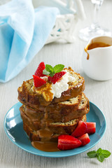 Dessert of banana cake with caramel sauce and strawberries.
