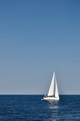 Fototapeta na wymiar White boat alone on open blue adriatic sea. Croatia