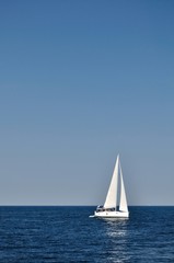 Obraz premium White boat alone on open blue adriatic sea. Croatia