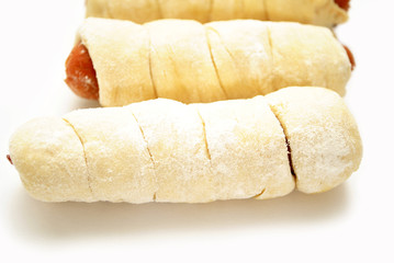Close-Up of Raw Pretzel Dogs Over White