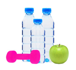 Blue bottles with water, dumbell and green apple isolated on whi