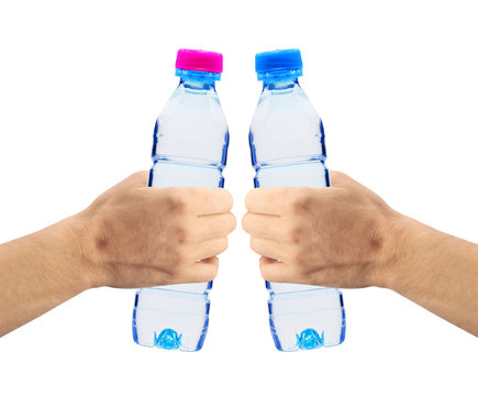 Human hands holding bottles of water isolated on white