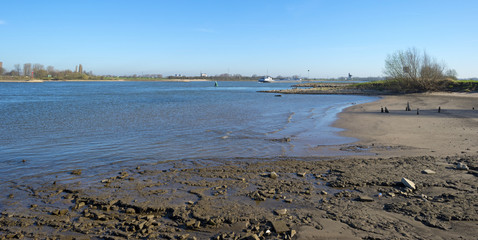 Ship sailing on a river under a clear sky