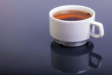Cup of tea on glossy table