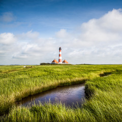 Fototapeta na wymiar Beautiful landscape with lighthouse at Nordsee, Germany