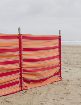A red striped windbreak on Cannon Beach on the Oregon coast.