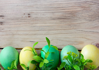 Easter eggs on wooden background with space for text
