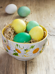 Colorful  easter eggs in bowl nets.